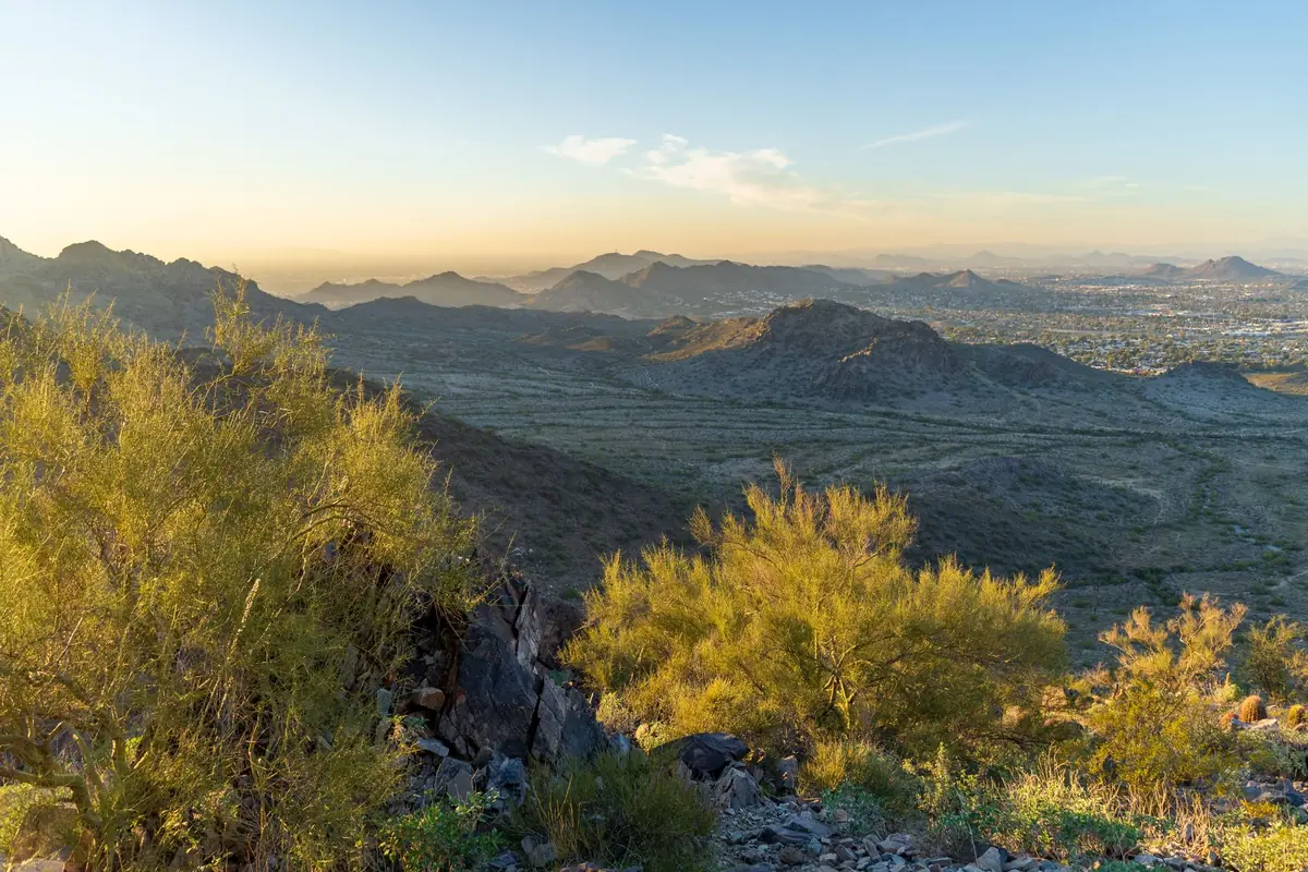 Golden light across Arizona desert mountains and low scrub
