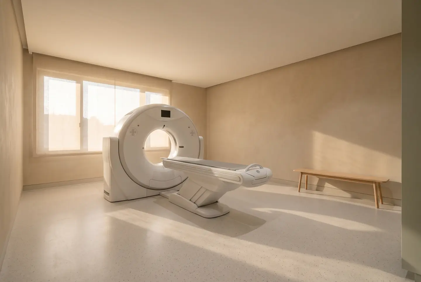 A quiet imaging room with a white scanner and diffused afternoon light